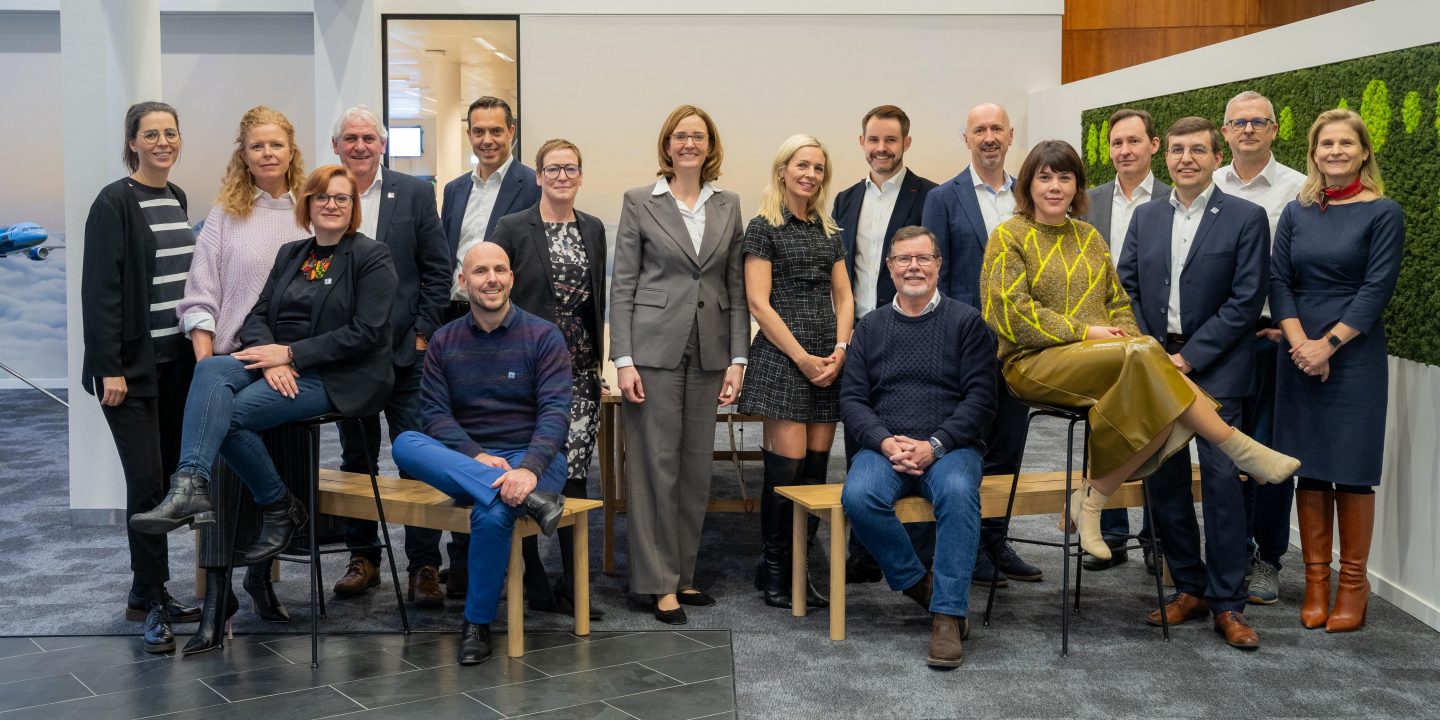 Colleagues at Brussels Airlines HQ posing for an office photo.