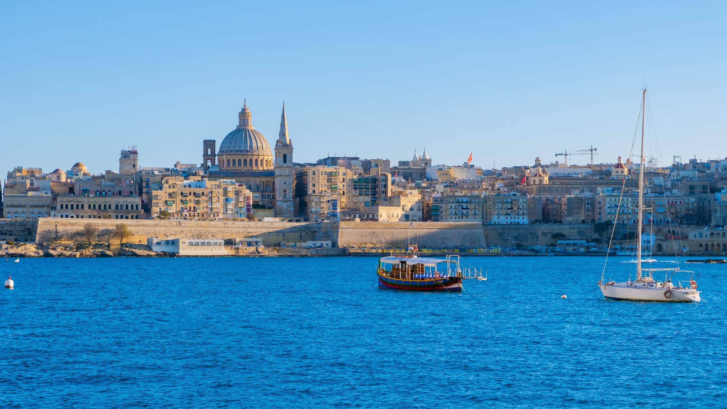 Valletta Malta city Skyline, colorful house balcony Malta Valletta, panoramic view over Valletta Malta old town at sunset