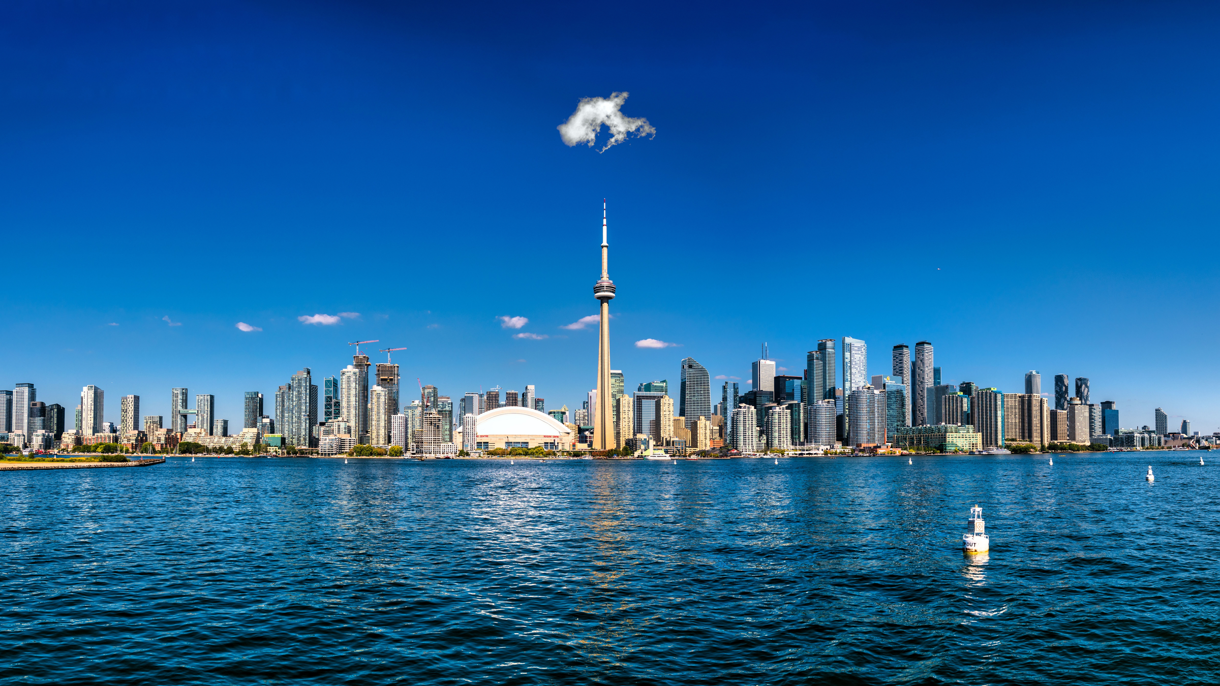 A scenic view of The Toronto skyline and CN Tower under the blue sky