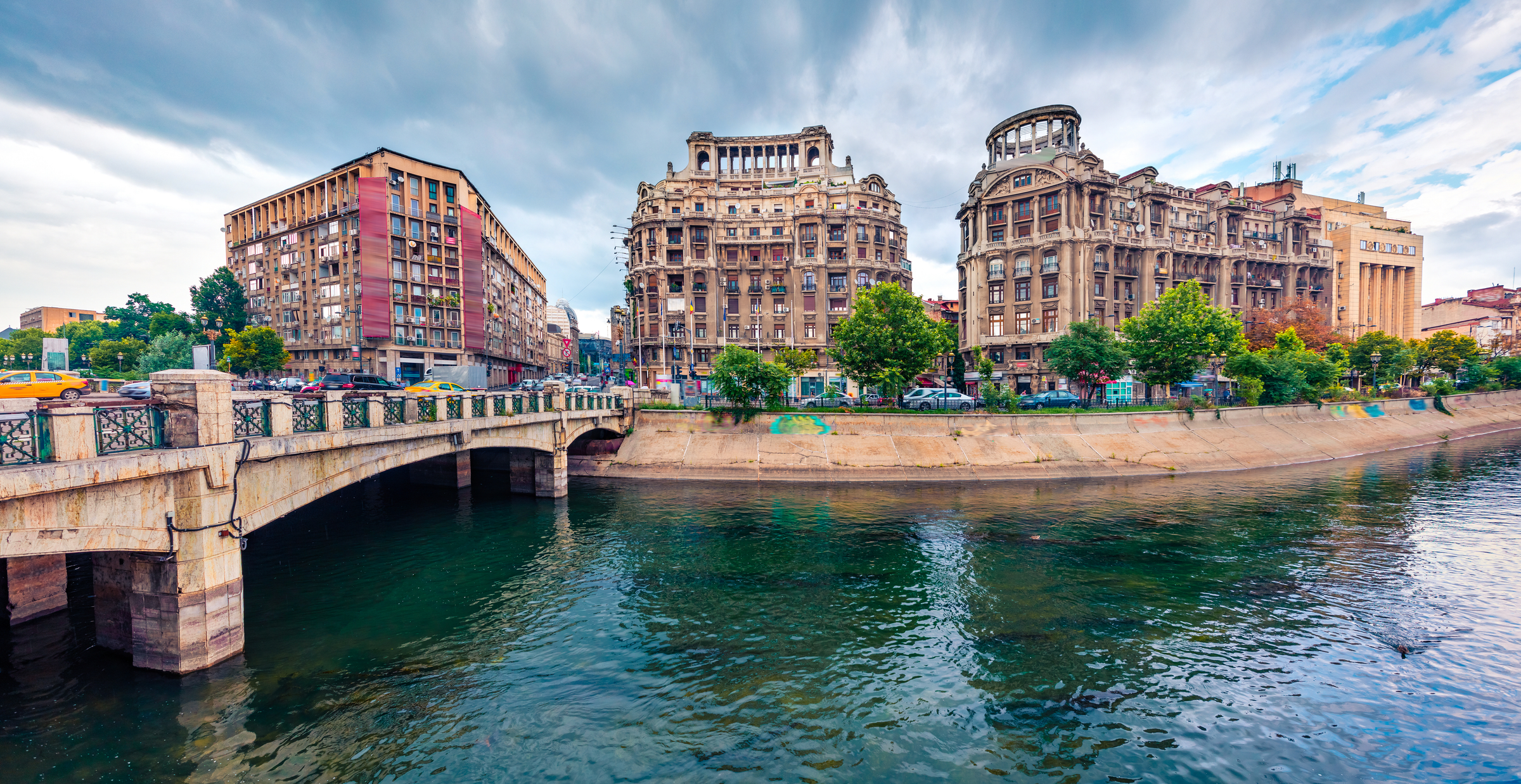 Splendid morning cityscape of Bucharest city - capital of Romania, Europe. Nice summer view of Dambovita River. Traveling concept background.