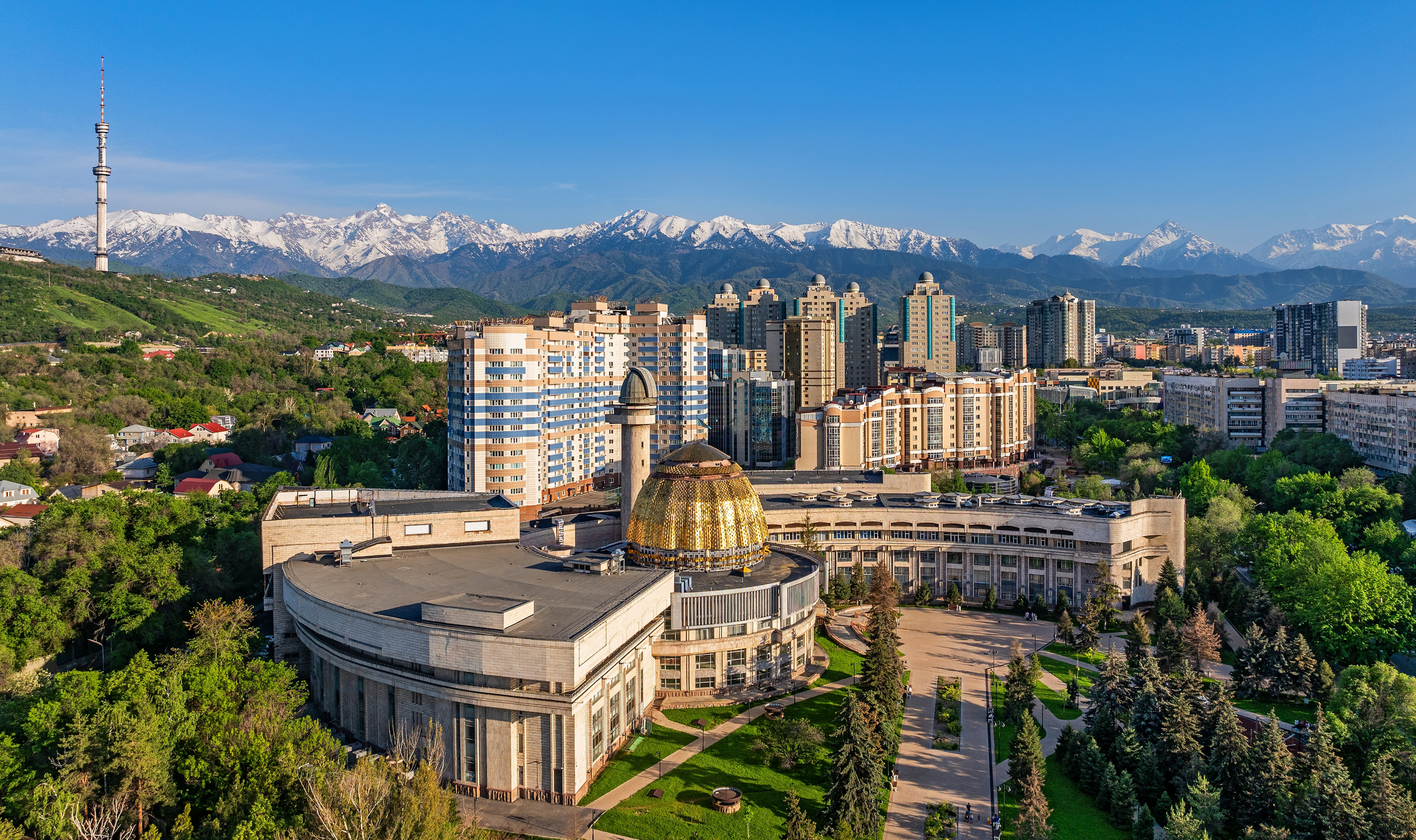 View from a quadcopter of the south-eastern part of the Kazakh city of Almaty against the backdrop of a mountain range on a sunny spring day