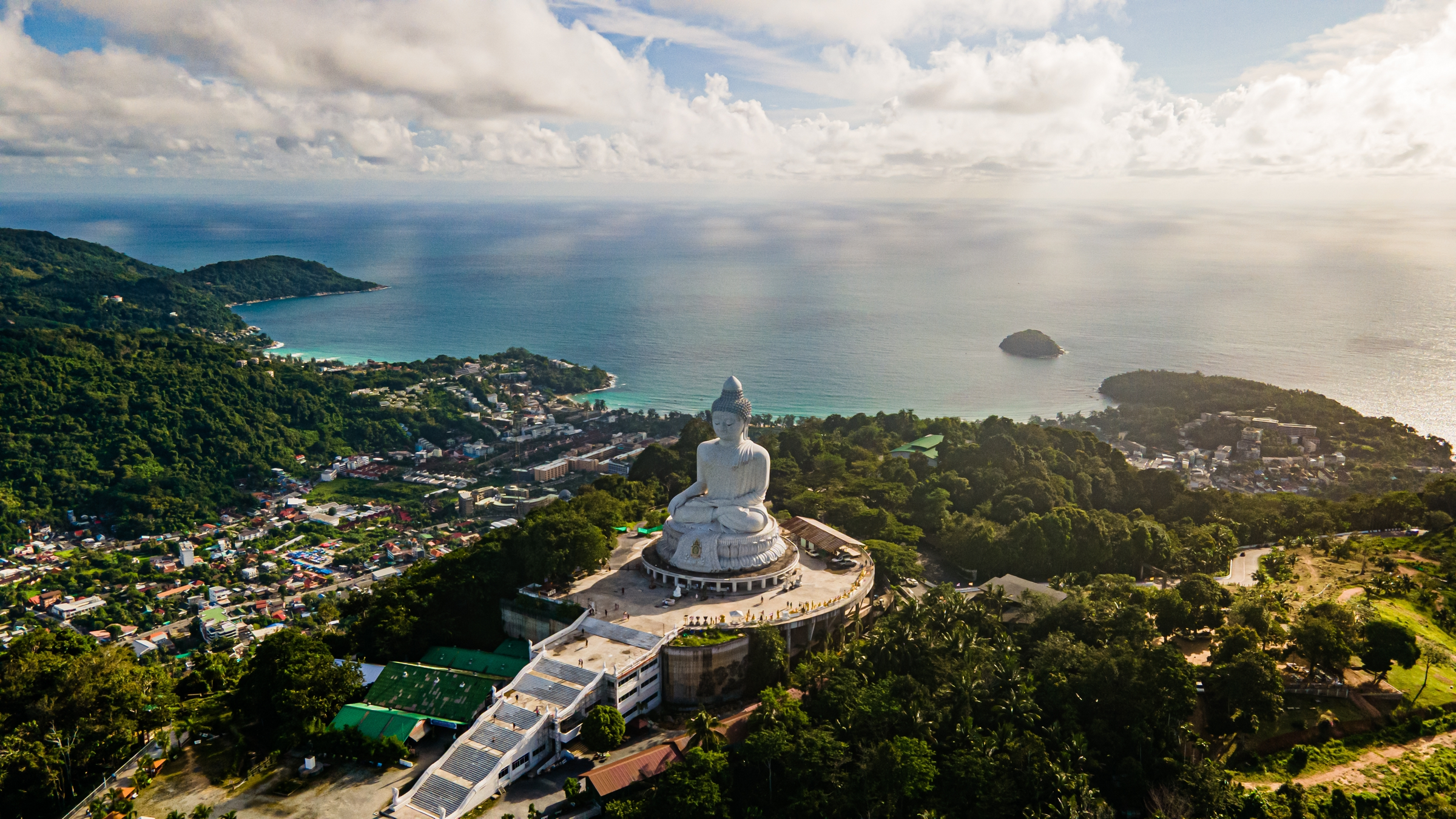 Phuket Big Buddha statue. afternoon light sky and blue ocean are on the back of white Phuket big Buddha is the one of landmarks on Phuket island Thailand.