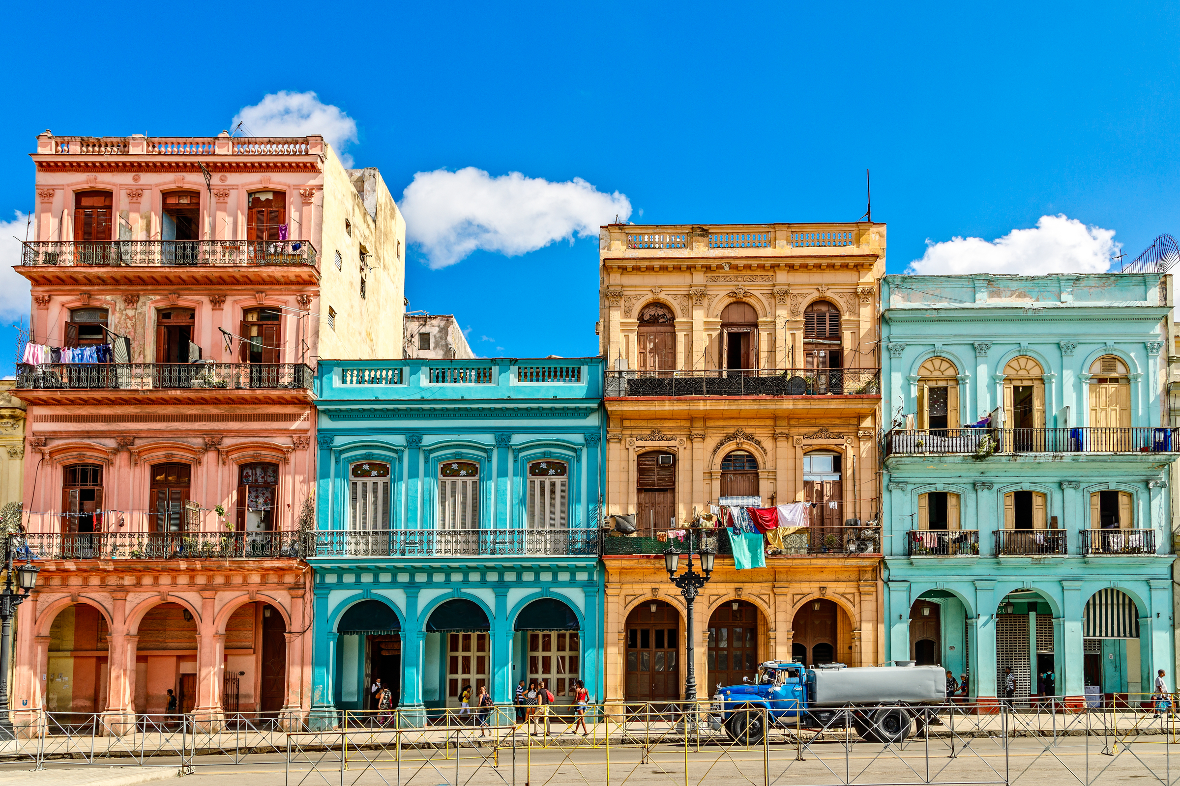 Old living colorful houses across the road in the center of Havana, Cuba