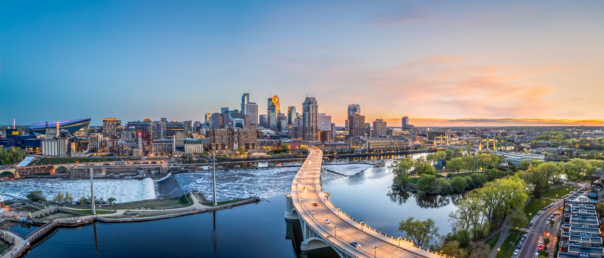 Minneapolis, Minnesota, USA downtown city skyline over the river at dusk.