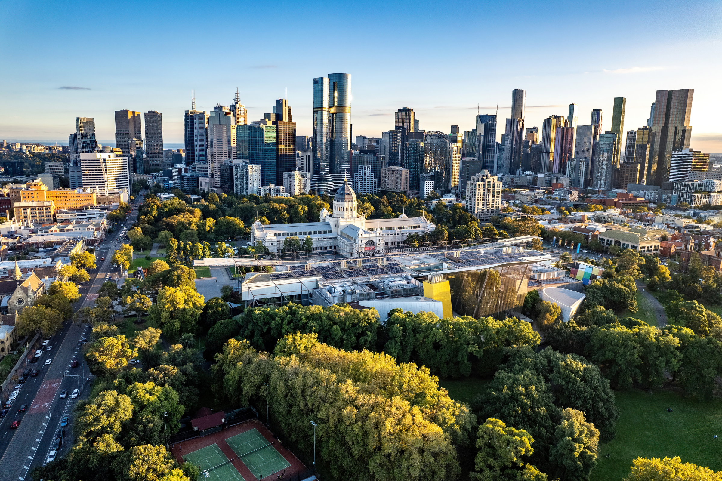 Melbourne, Victoria, Australia - April 14, 2024: Melbourne city skyline and Carlton Gardens with the Melbourne Museum and Royal Exhibition Building in the foreground. 