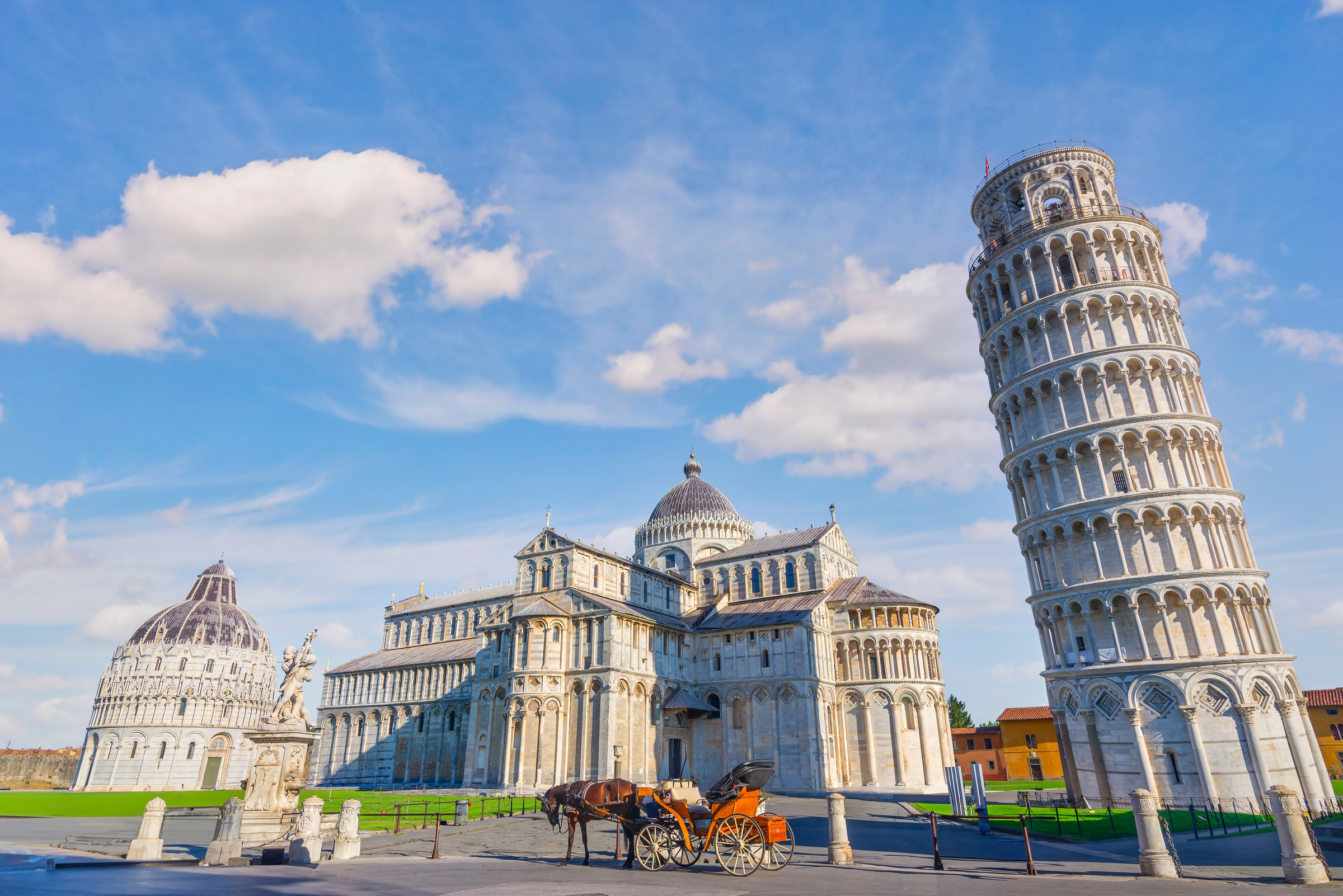 Horse with carriage on the square with Pisa leaning tower and cathedrals, Italy