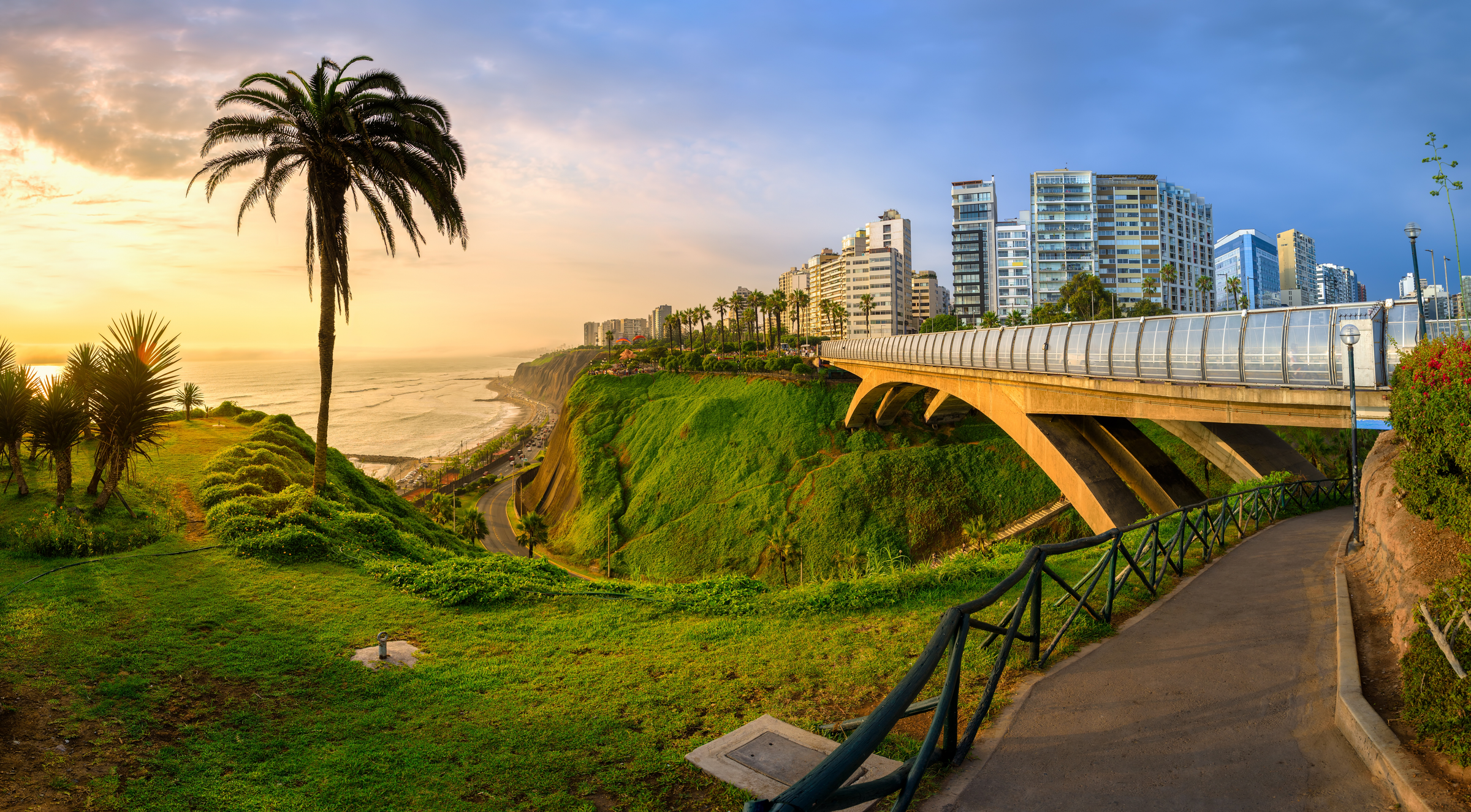 Malecon and Eduardo Villena Rey Bridge in Miraflores district on Pacific ocean coast in Lima city downtown, Peru, South America, in dramatic sunset light