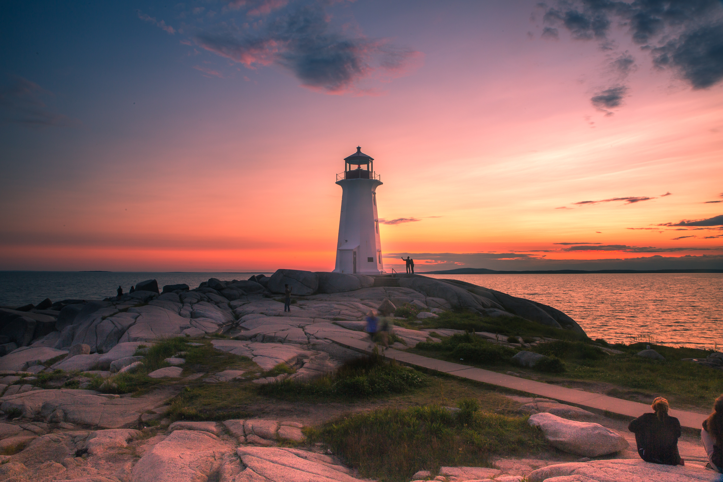 A dramatic sunset at Peggy's Cove Lighthouse, Atlantic Coast, Nova Scotia, Canada. The most visited tourist location in the Atlantic Canada and famous Lighthouse captured with vibrant colors