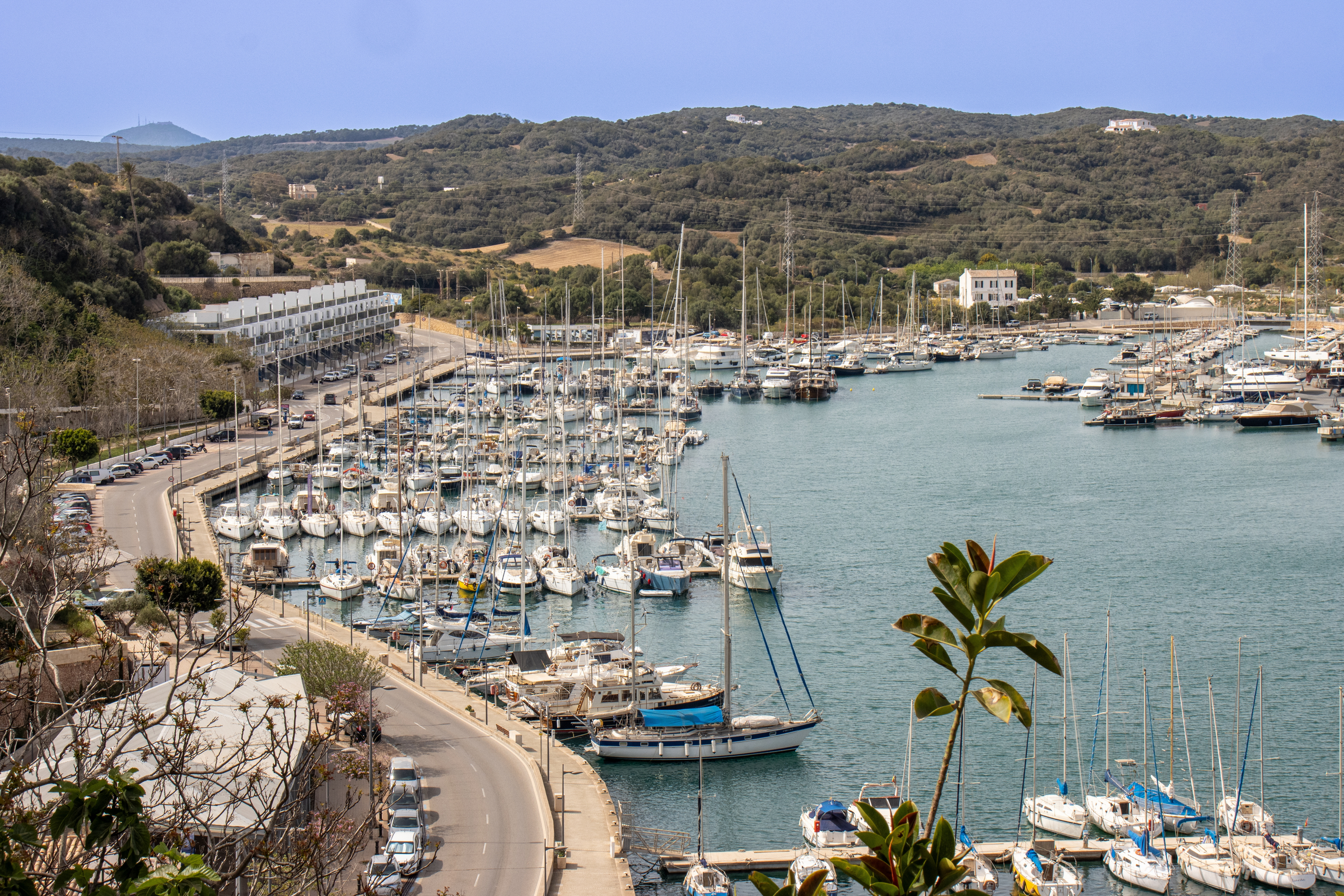 Panoramic photograph captured from the top of a viewpoint in the port of Mahón. It is an impressive sight. Boats and yachts sway gently in the calm waters of the harbor. Mahon, Menorca, Spain