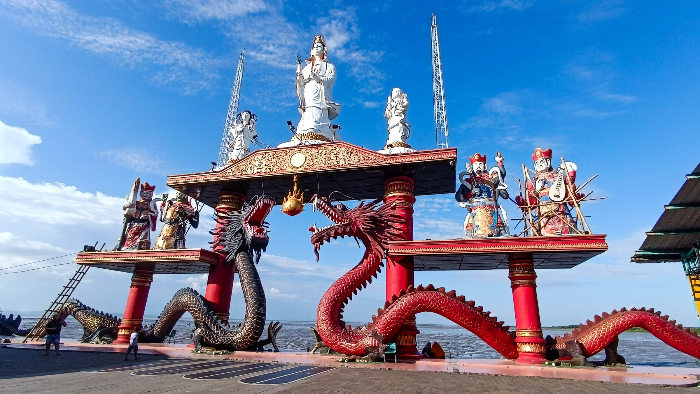 Seaside landmark of the Goddess Kwan Im and a pair of dragons at Sanggar Agung Temple, Kenjeran Park, Surabaya, Indonesia. This area is a place of worship for Buddhists, Confucians, and Taoists.