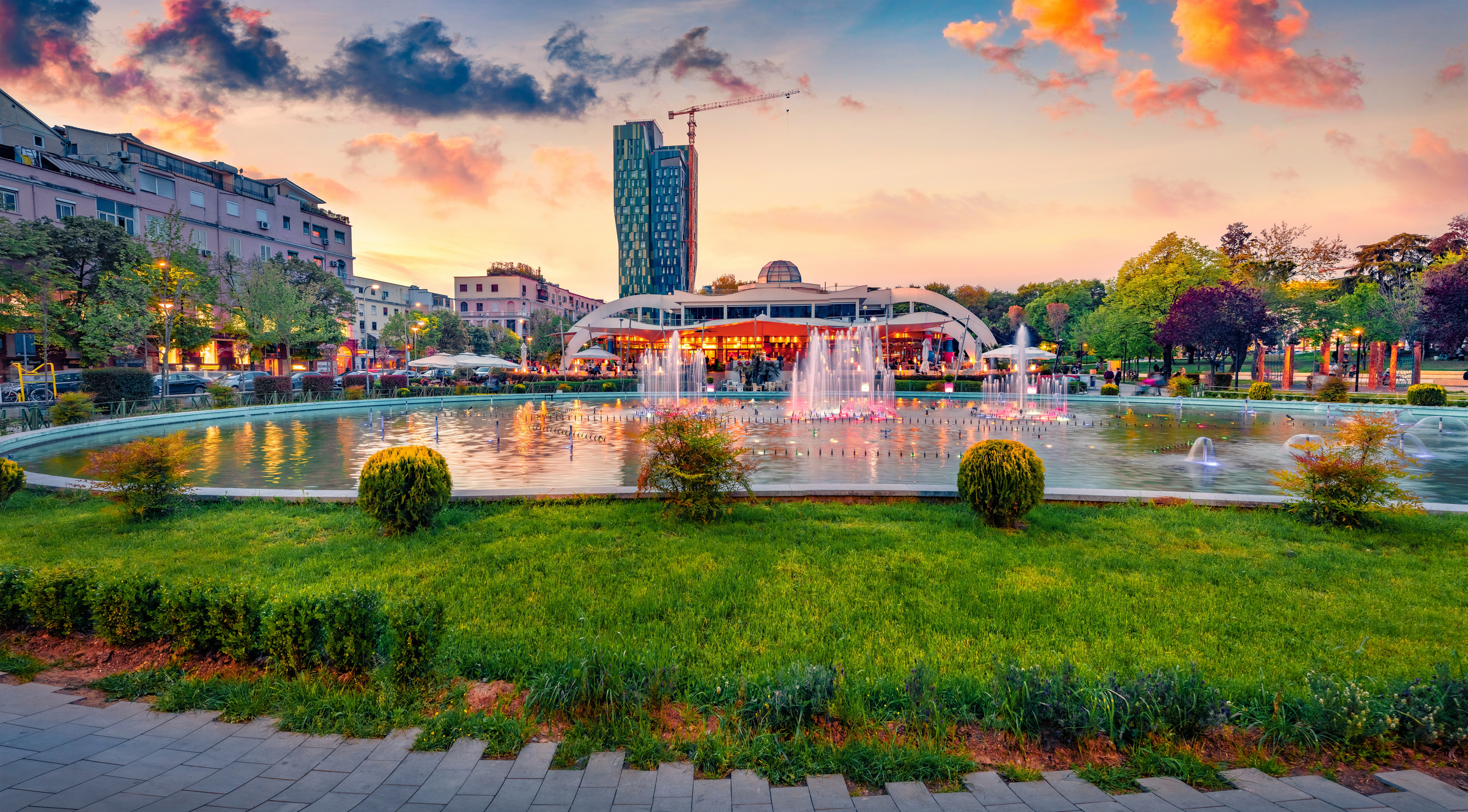 Wonderful spring view of Scanderbeg Square with illuminated fountain. Beautiful sunset in capital of Albania - Tirana. Traveling concept background.