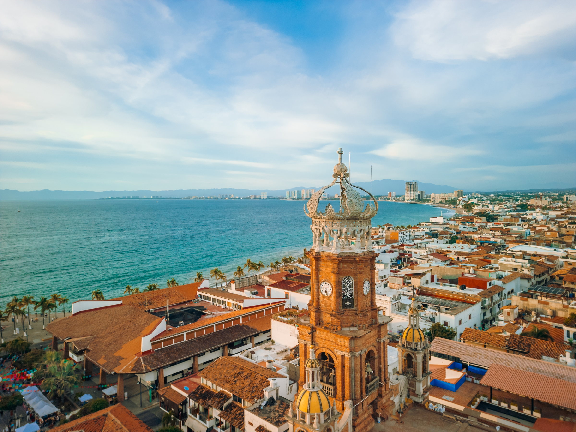 Aerial view of our Lady of Guadalupe church in Puerto Vallarta, Mexico and ocean at golden hour.