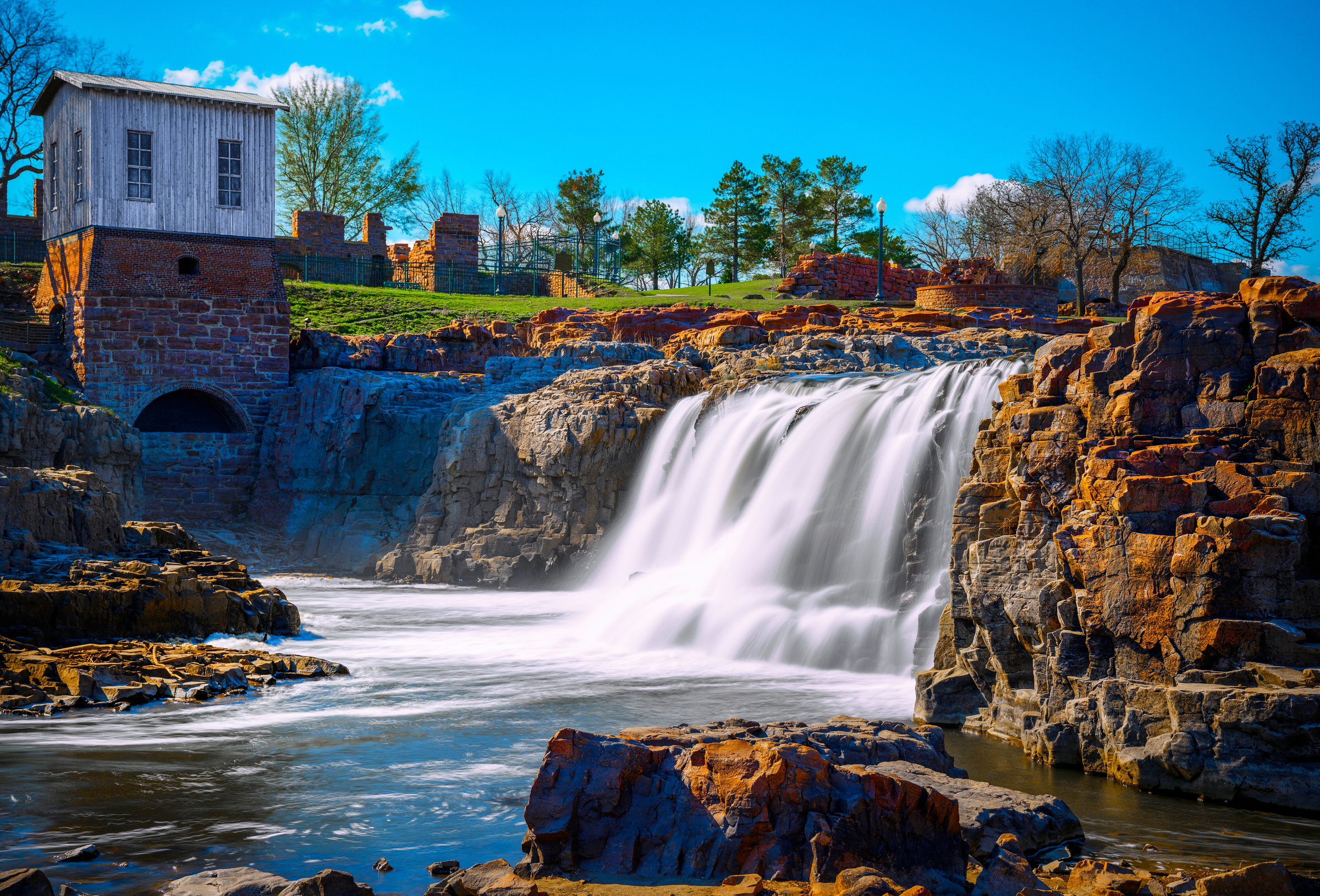 Sioux Falls City Spring Landscape at the Falls Park in Sioux Falls, South Dakota, USA, silky water falling over quartzite and pipestone rock formations in the Big Sioux River