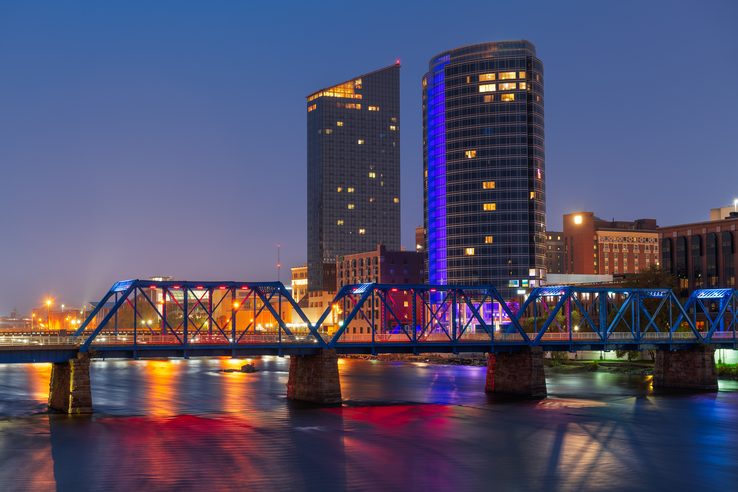 Grand Rapids, Michigan, USA downtown skyline on the Grand River at dusk.