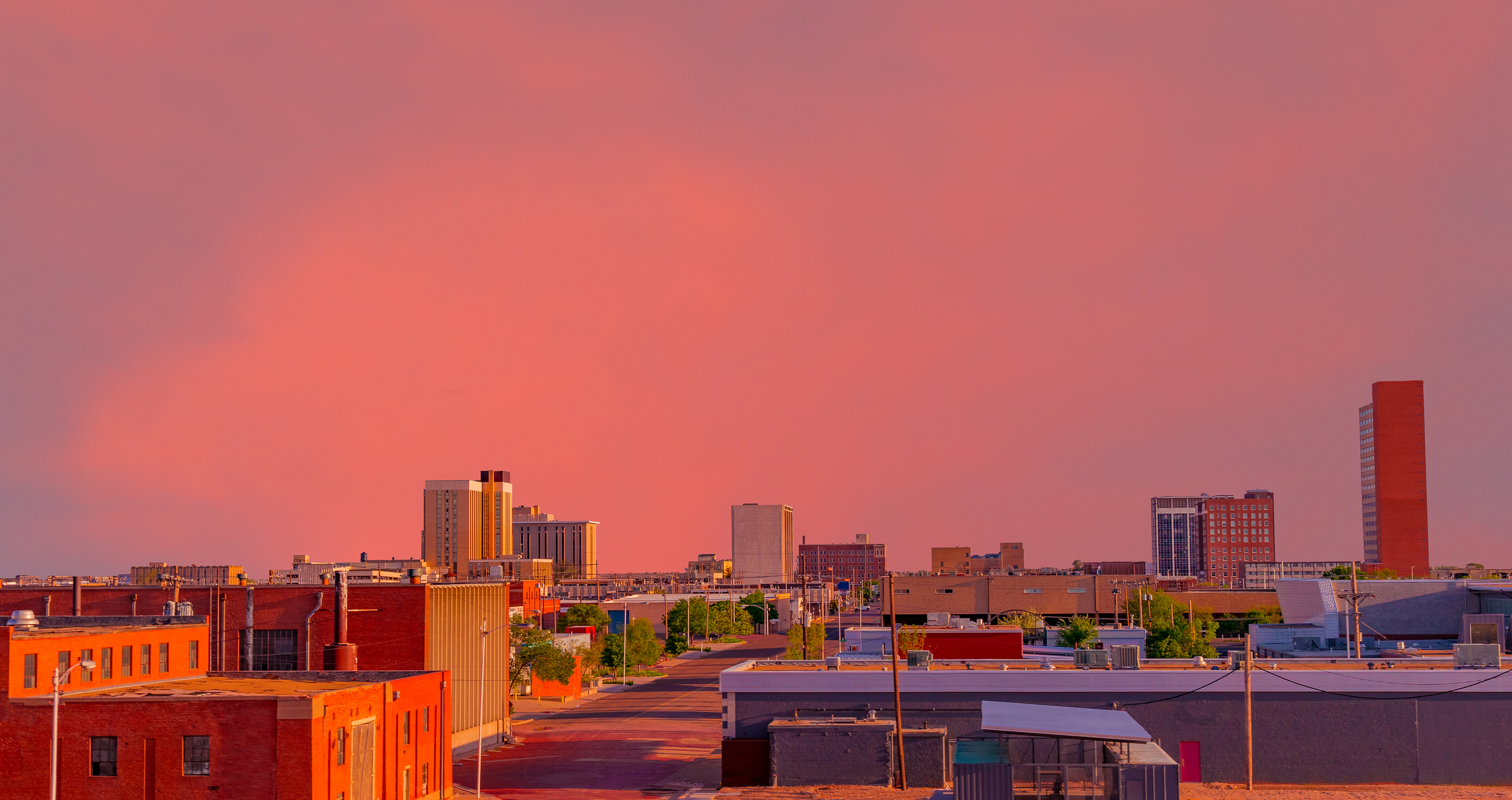 Looking down at the downtown district with a brilliant sunset creating color everywhere in Lubbock, Texas.