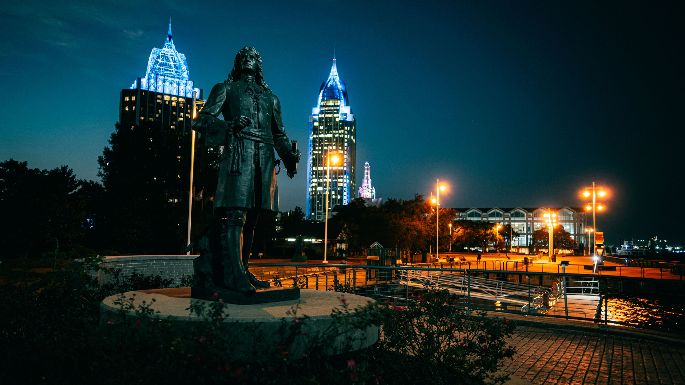 A beautiful view of the Pierre d'Iberville Statue with skylines in Mobile, Alabama 2022