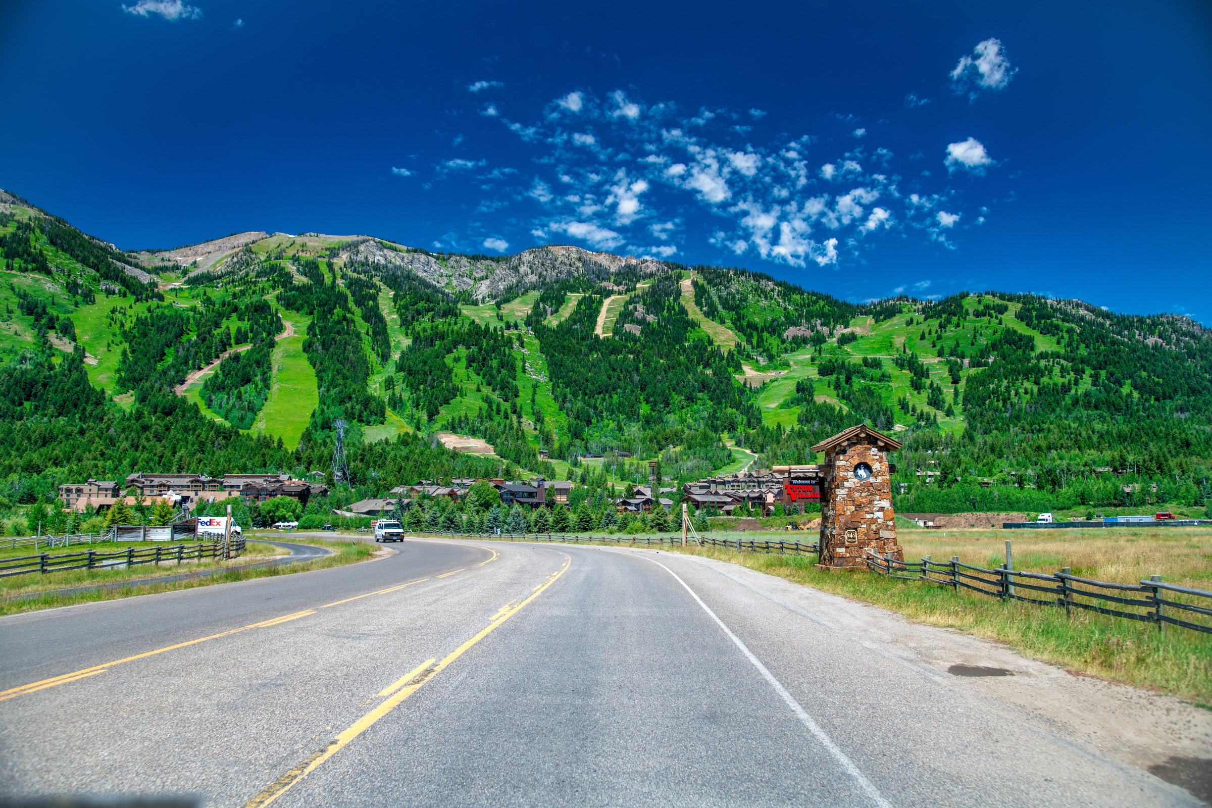 Amazing view of Jackson Village with road and mountains in summer season, Wyoming.