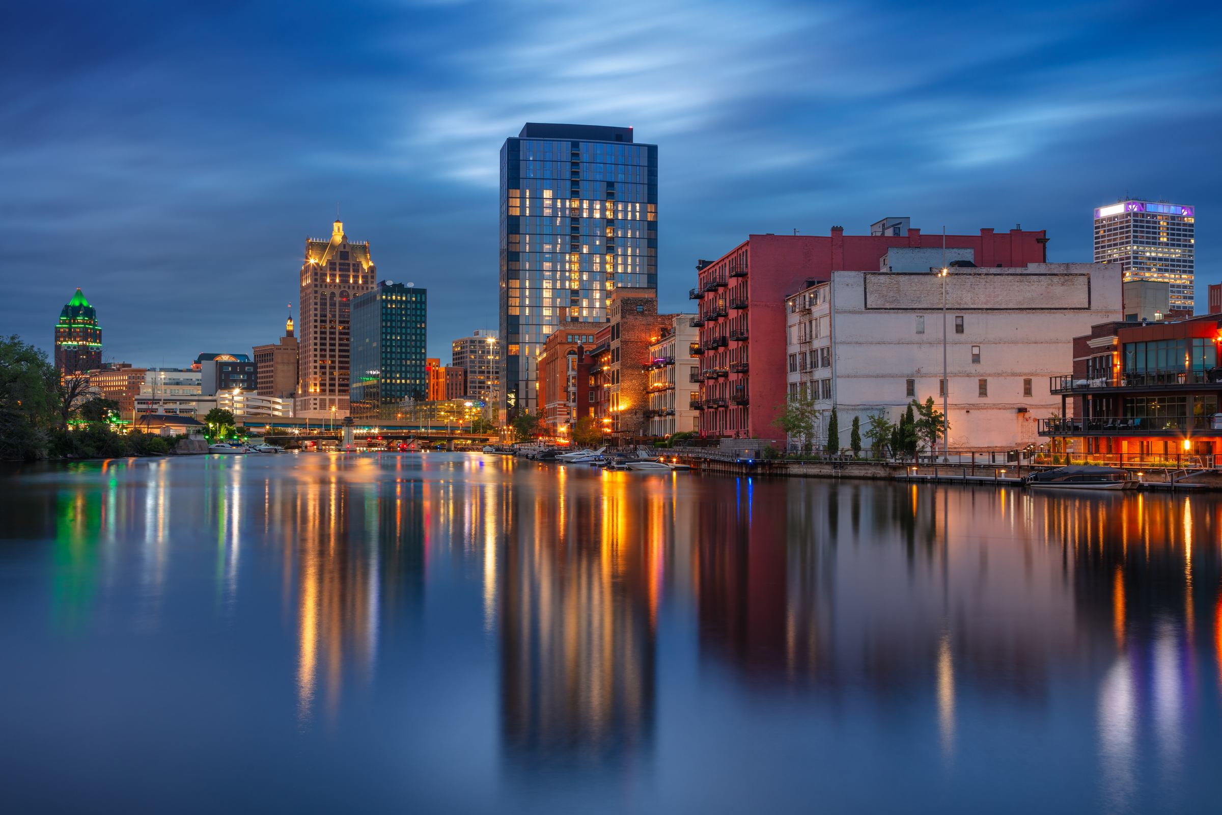 Milwaukee, Wisconsin, USA. Cityscape image of downtown Milwaukee, Wisconsin, USA with reflection of the skyline in Mnemonee River at twilight blue hour.