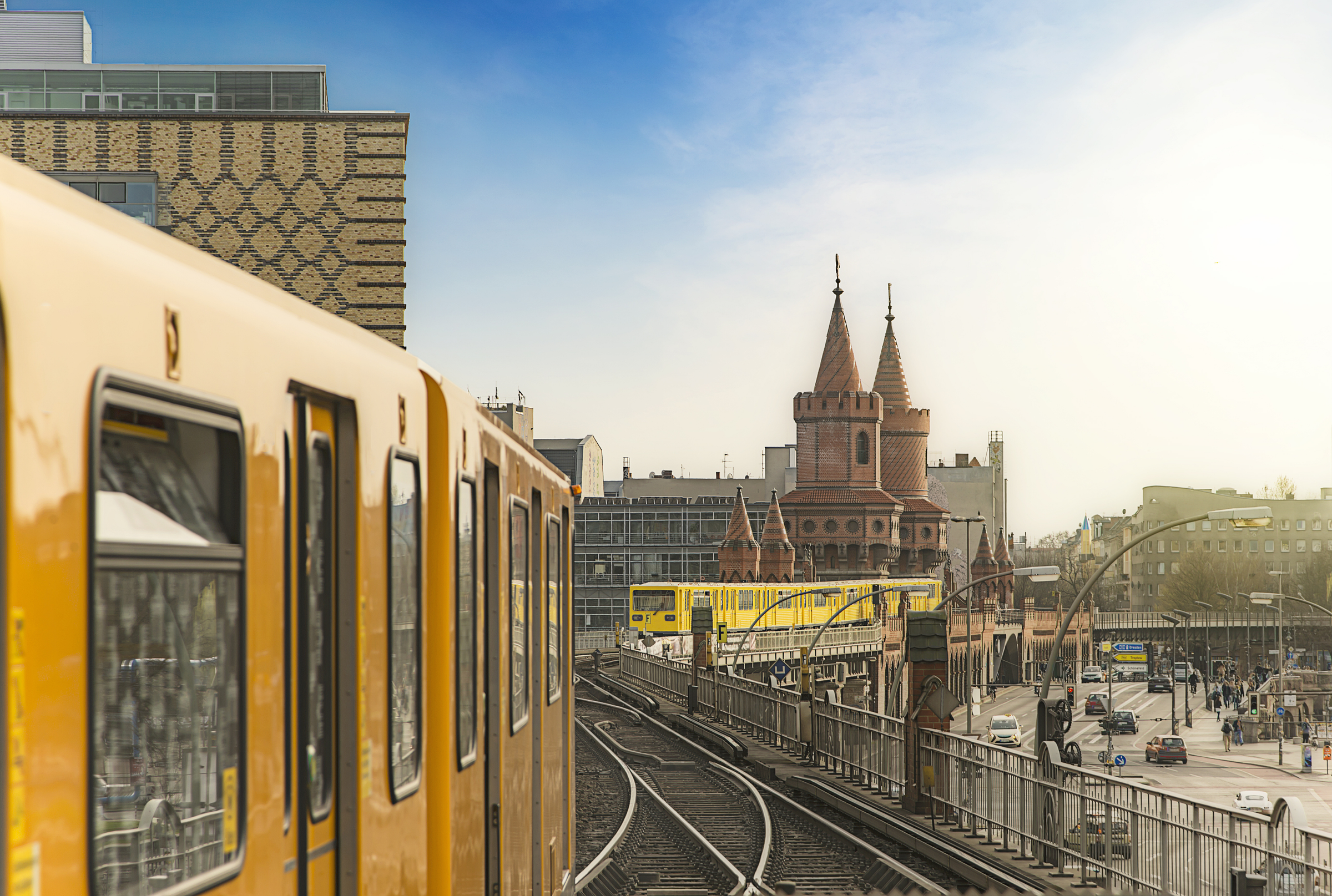 Panoramic view of Berliner U-Bahn trains with Oberbaumbridge in the background in golden evening light at sunset, Berlin Friedrichshain-Kreuzberg, Germany