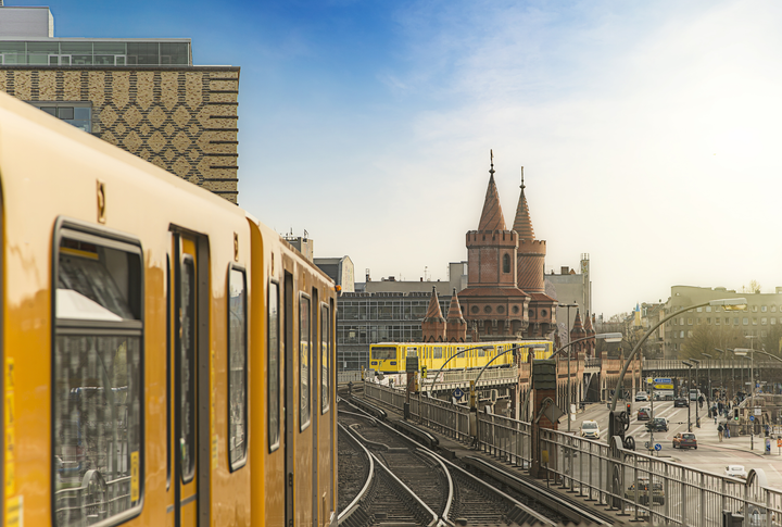 Panoramic view of Berliner U-Bahn trains with Oberbaumbridge in the background in golden evening light at sunset, Berlin Friedrichshain-Kreuzberg, Germany