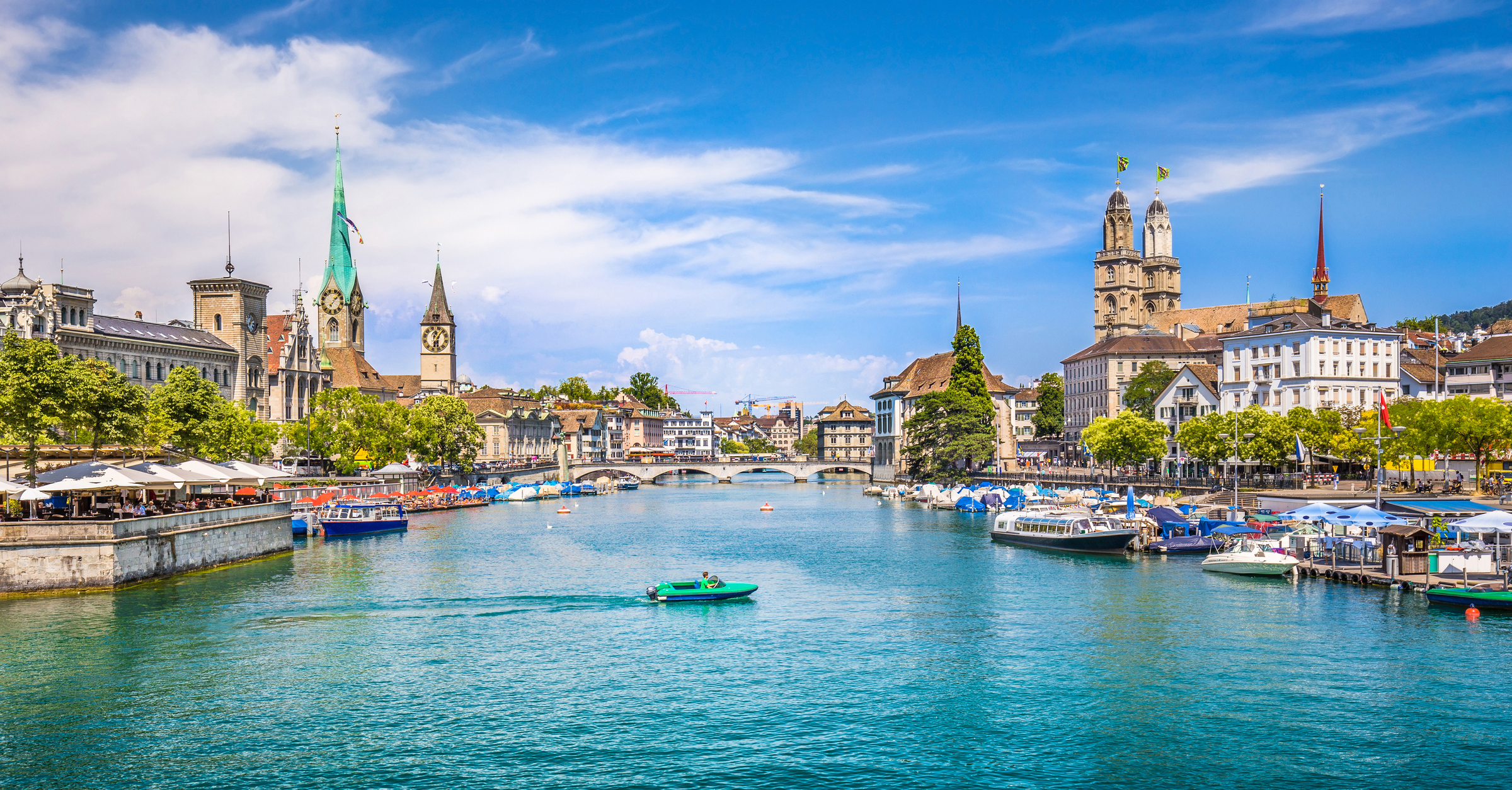 Panoramic view of historic Zurich city center with famous Fraumunster and Grossmunster Churches and river Limmat at Lake Zurich on a sunny day with clouds in summer, Canton of Zurich, Switzerland