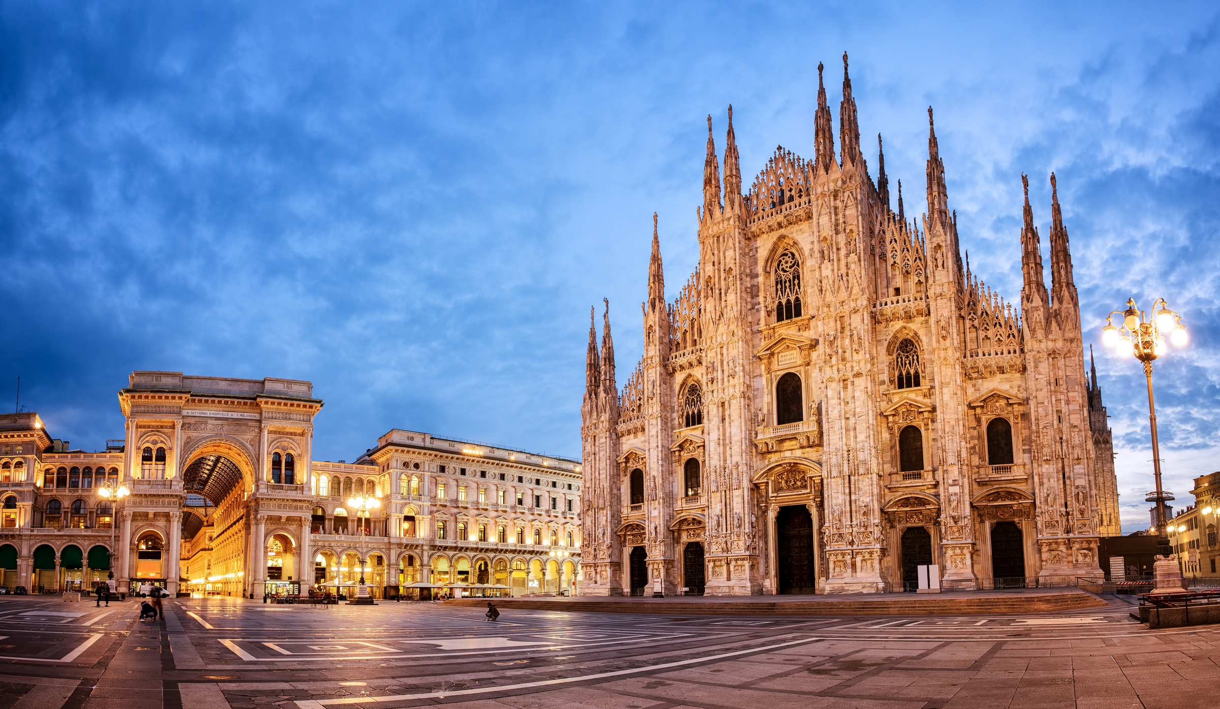 Milan Cathedral and the detail of the lion at the base of the monument to Vittorio Emanuele II