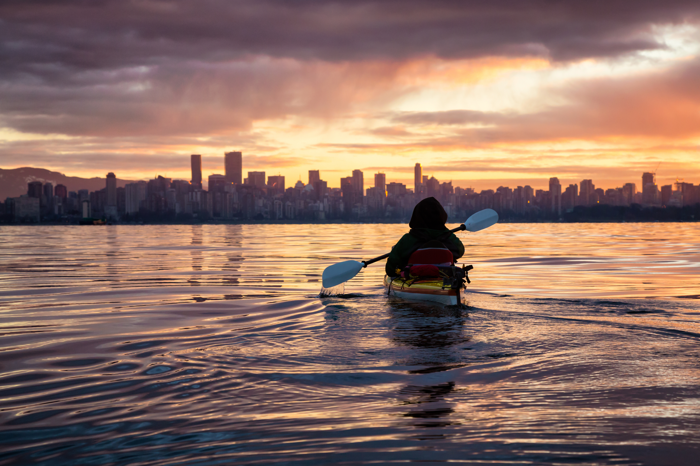 Kayaking around Vancouver Downtown, BC, Canada, during a beautiful winter sunrise.