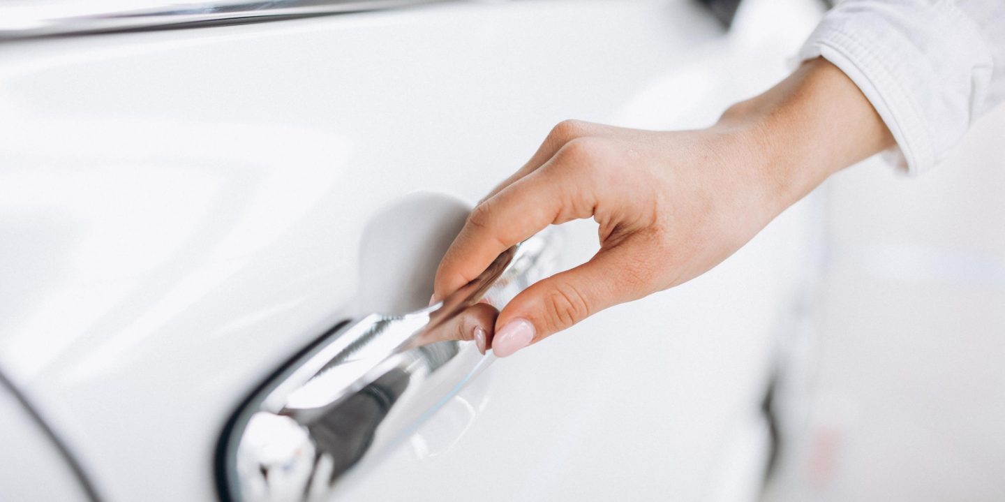 Female hand opening car close up