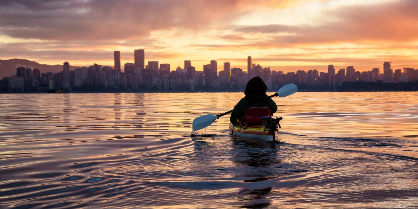 Kayaking around Vancouver Downtown, BC, Canada, during a beautiful winter sunrise.